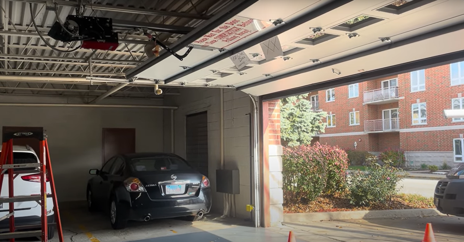 "Professional technician inspecting and repairing an overhead garage door mechanism with tools in the background, ensuring smooth functionality – Expert Garage Door Repair.